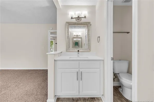 a bathroom with a sink toilet and mirror