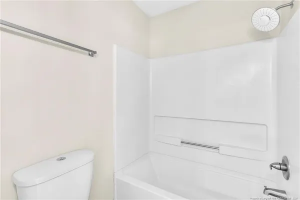 a bathroom with a toilet and a bathtub