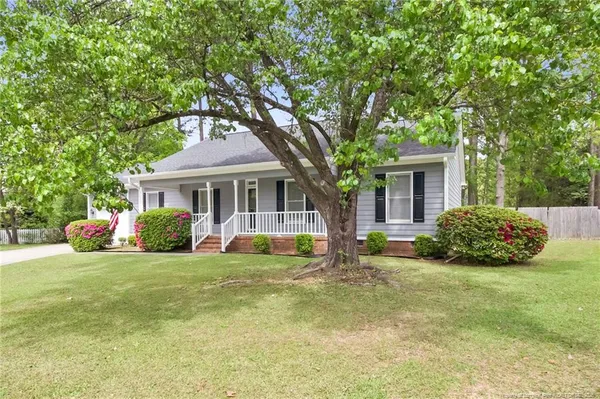 a view of a house with a yard and sitting area