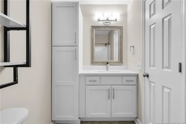 a bathroom with a sink vanity and mirror