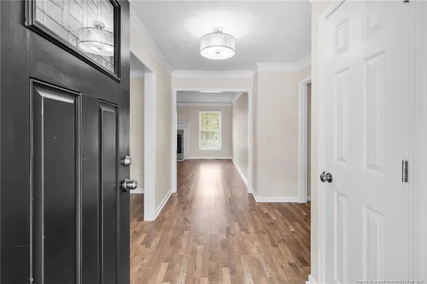 a view of hallway with wooden floor