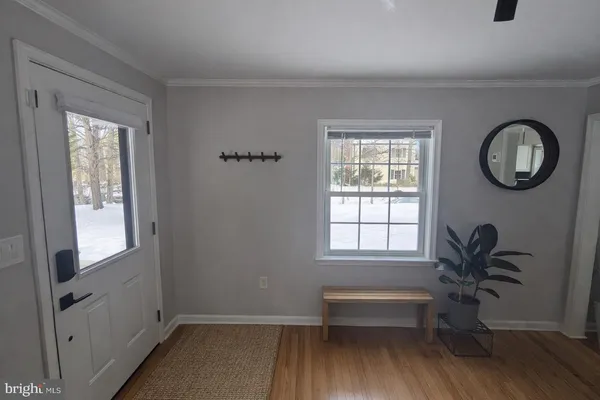 a view of a room with wooden floor and window
