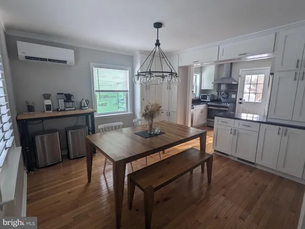 a kitchen with sink cabinets and wooden floor