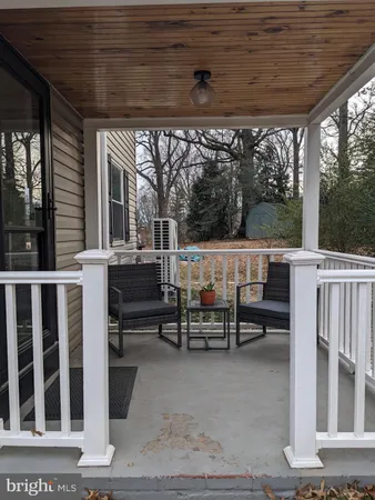 a view of a patio with table and chairs and wooden fence