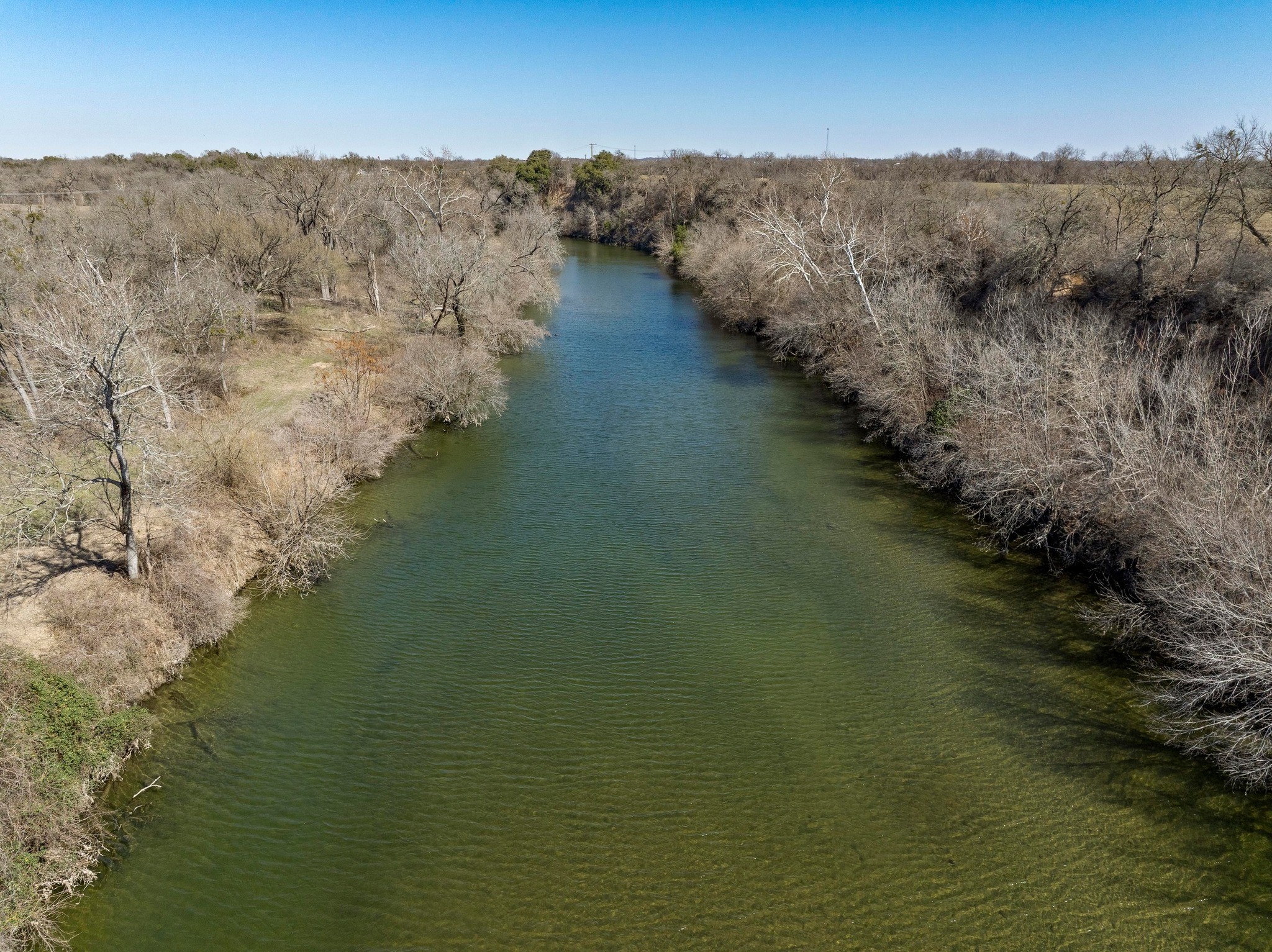 105 River Valley Drive Georgetown, TX 78626 - Photo 5 of 29 a view of a lake in middle of forest