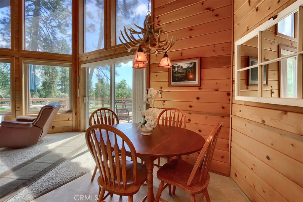 5027 Fox Creek Road Mariposa, CA 95338 - Photo 14 of 75 a view of a dining room with furniture a chandelier and wooden floor