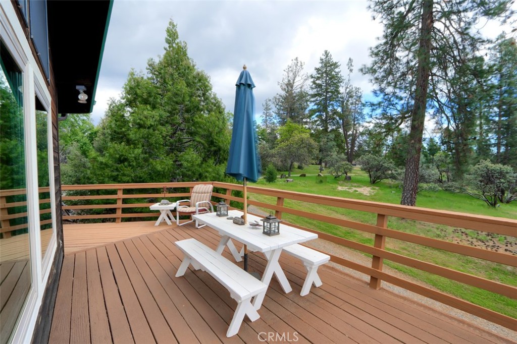 5027 Fox Creek Road Mariposa, CA 95338 - Photo 39 of 75 a balcony with wooden floor and outdoor seating