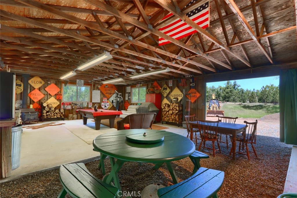 5027 Fox Creek Road Mariposa, CA 95338 - Photo 55 of 75 a view of a backyard with table and chairs couches with wooden floor and fence