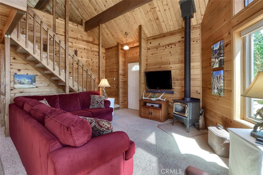 5027 Fox Creek Road Mariposa, CA 95338 - Photo 6 of 75 a living room with furniture a flat screen tv and a fireplace