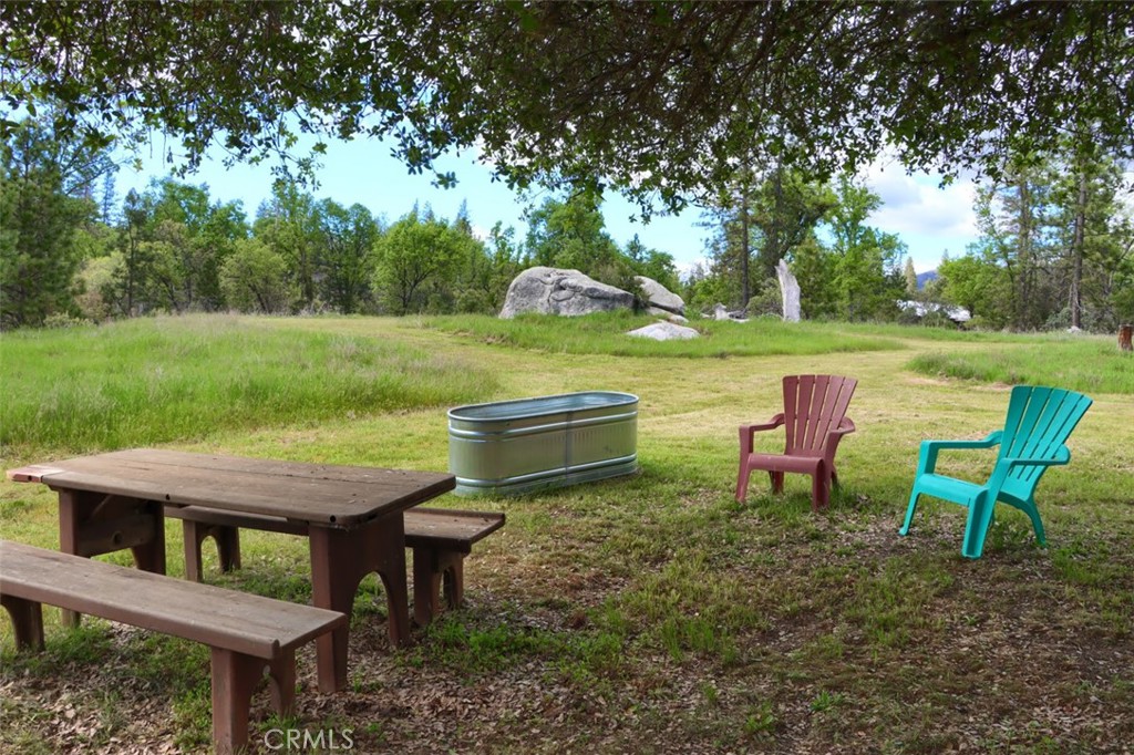 5027 Fox Creek Road Mariposa, CA 95338 - Photo 65 of 75 a view of a wooden chairs and table in the garden