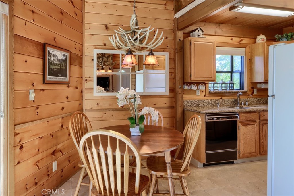 5027 Fox Creek Road Mariposa, CA 95338 - Photo 10 of 75 a view of a kitchen with stainless steel appliances granite countertop a stove a sink a dining table and chairs