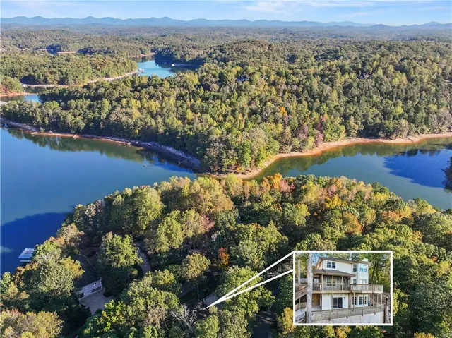 an aerial view of a house with a lake view