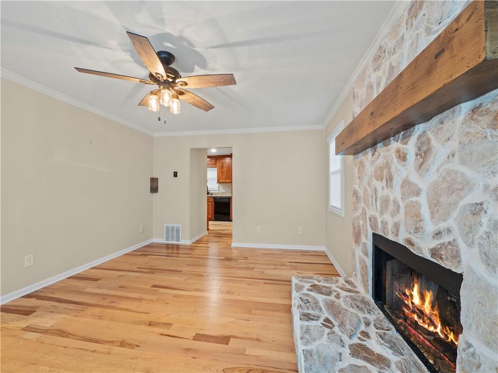 6185 Timberidge Drive Gainesville, GA 30506 - Photo 14 of 50 a view of empty room with a fireplace and wooden floor