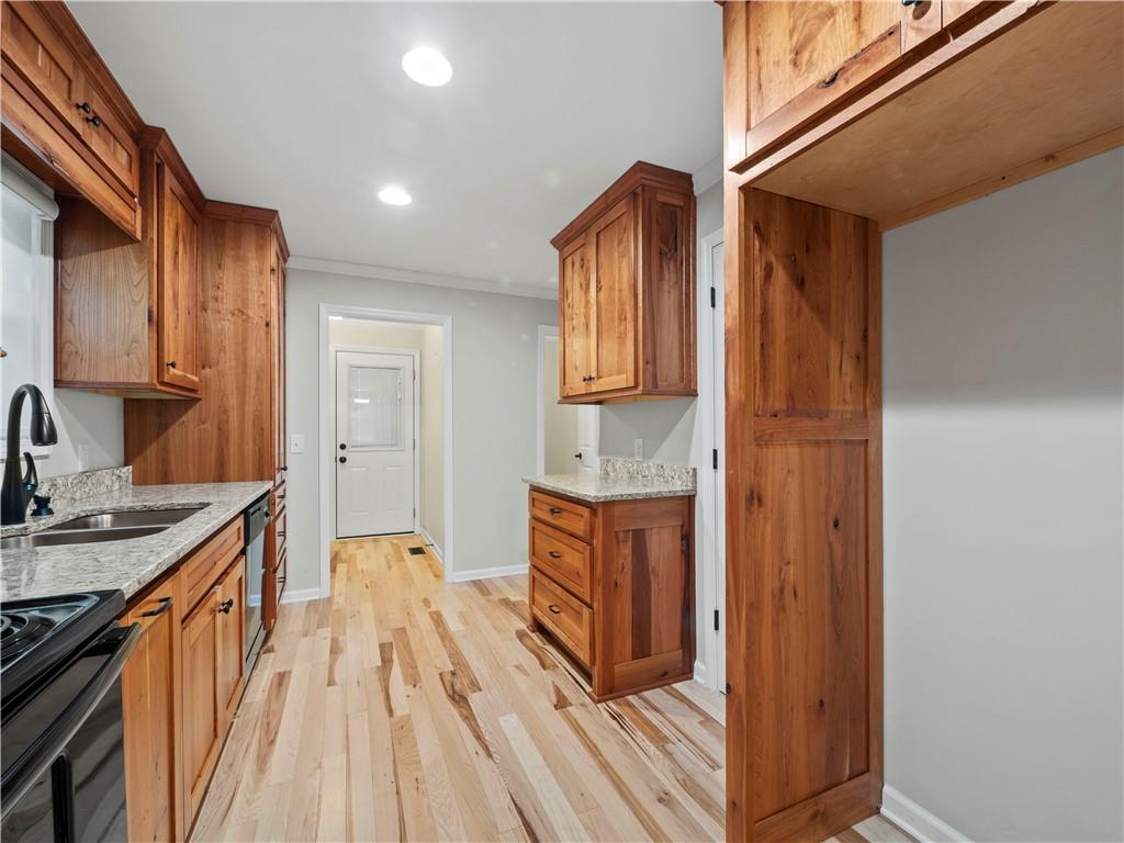 6185 Timberidge Drive Gainesville, GA 30506 - Photo 26 of 50 a open kitchen with stainless steel appliances granite countertop a refrigerator a sink dishwasher and wooden cabinets with wooden floor