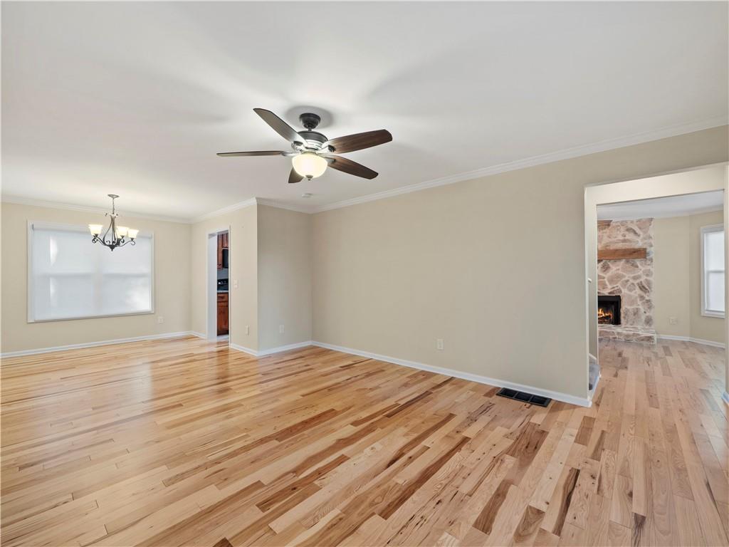 6185 Timberidge Drive Gainesville, GA 30506 - Photo 30 of 50 a view of an empty room with wooden floor and a ceiling fan