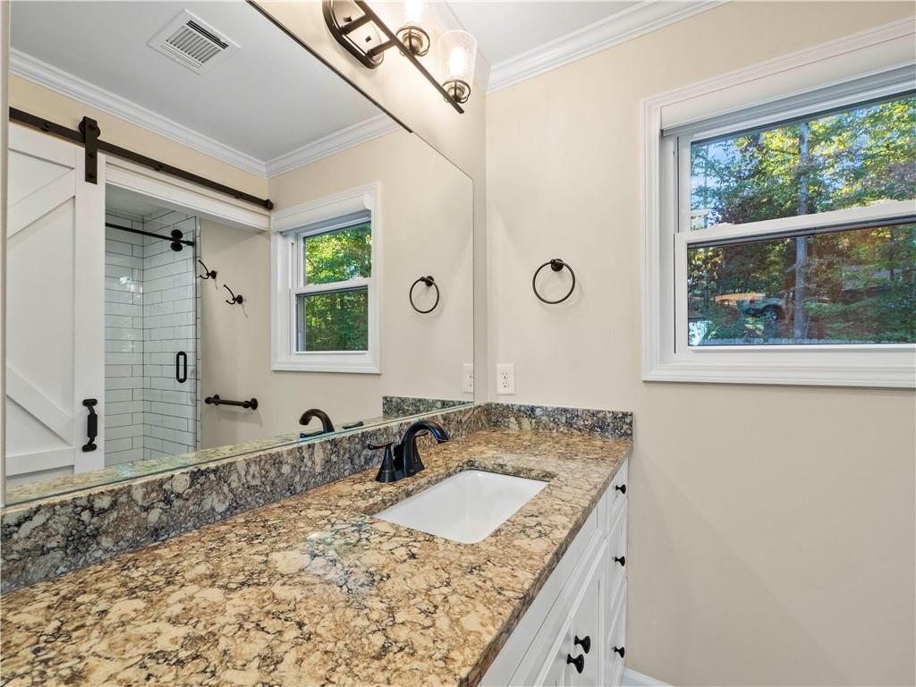 6185 Timberidge Drive Gainesville, GA 30506 - Photo 38 of 50 a bathroom with a granite countertop sink and a large mirror