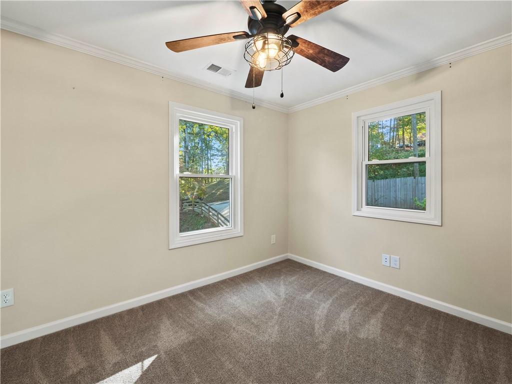 6185 Timberidge Drive Gainesville, GA 30506 - Photo 40 of 50 an empty room with a window and a fan