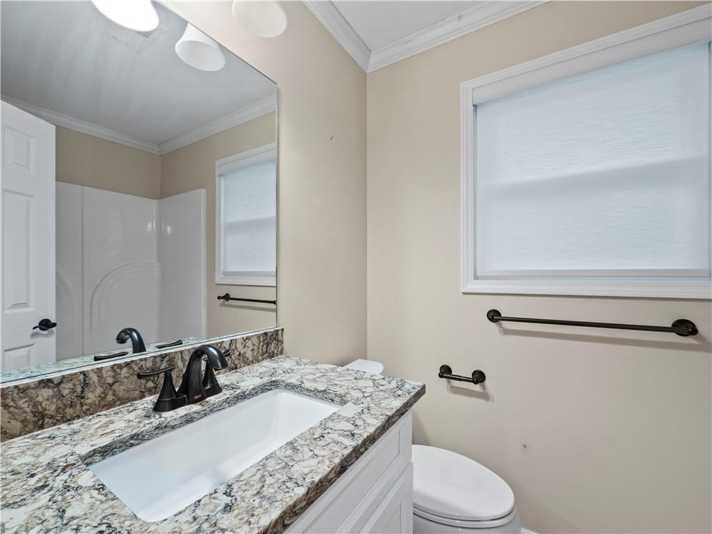 6185 Timberidge Drive Gainesville, GA 30506 - Photo 44 of 50 a bathroom with a granite countertop sink mirror vanity and toilet