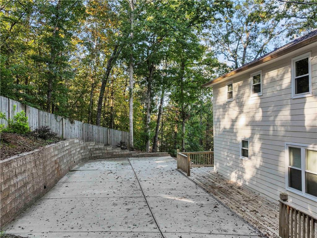 6185 Timberidge Drive Gainesville, GA 30506 - Photo 8 of 50 a view of backyard with potted plants and wooden fence