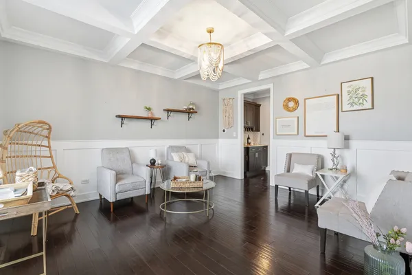 a living room with furniture and a chandelier