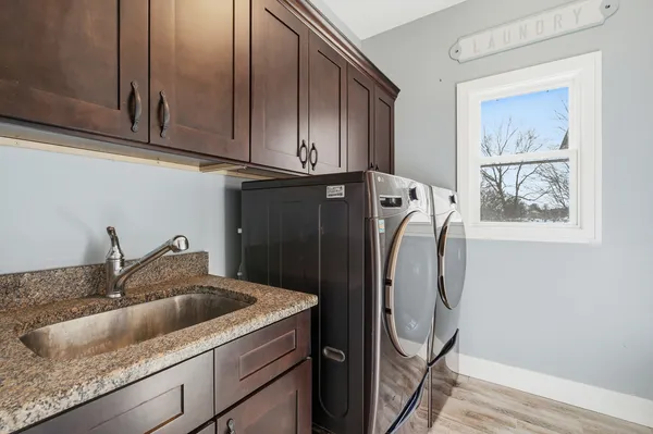 a kitchen with stainless steel appliances kitchen island granite countertop a refrigerator and a stove top oven