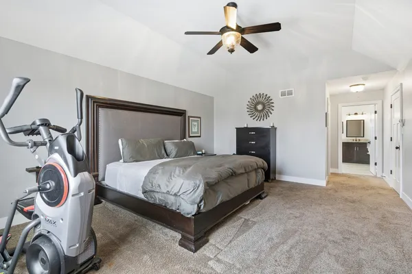a bedroom with a bed and a chandelier