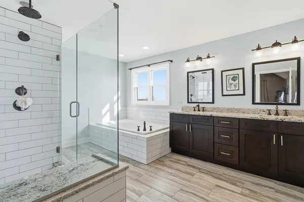 a bathroom with a granite countertop toilet sink and mirror