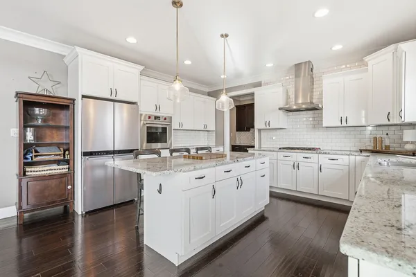 a kitchen with appliances cabinets and furniture
