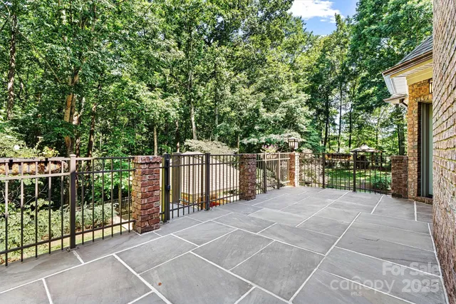 a view of a fence and trees