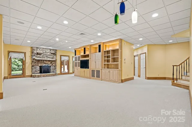 an empty room with a ceiling fan and window