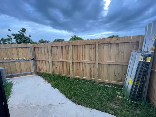 25308 Southwest 135th Avenue Homestead, FL 33032 - Photo 20 of 25 a view of a backyard with wooden fence