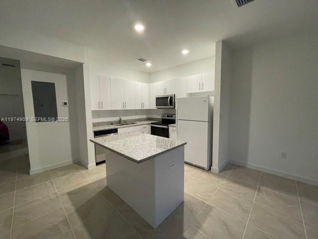 25308 Southwest 135th Avenue Homestead, FL 33032 - Photo 24 of 25 a kitchen with a sink a refrigerator and cabinets