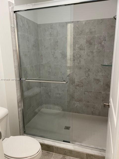25308 Southwest 135th Avenue Homestead, FL 33032 - Photo 10 of 25 a bathroom with a shower and a toilet