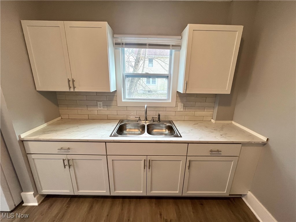 827 Inman Street Akron, OH 44306 - Photo 7 of 15 Kitchen featuring white cabinets, a sink, and tasteful backsplash