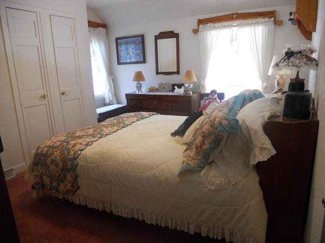 18442 East Twombly Road Rochelle, IL 61068 - Photo 13 of 20 a bed sitting in a bedroom next to a window