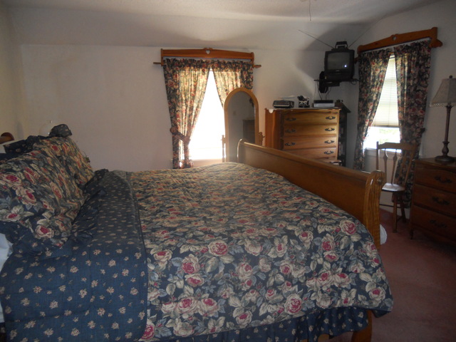 18442 East Twombly Road Rochelle, IL 61068 - Photo 15 of 20 a bed sitting in a bedroom next to a window
