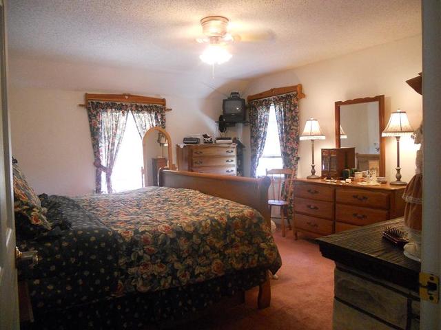 18442 East Twombly Road Rochelle, IL 61068 - Photo 16 of 20 a bedroom with a bed dresser and a window