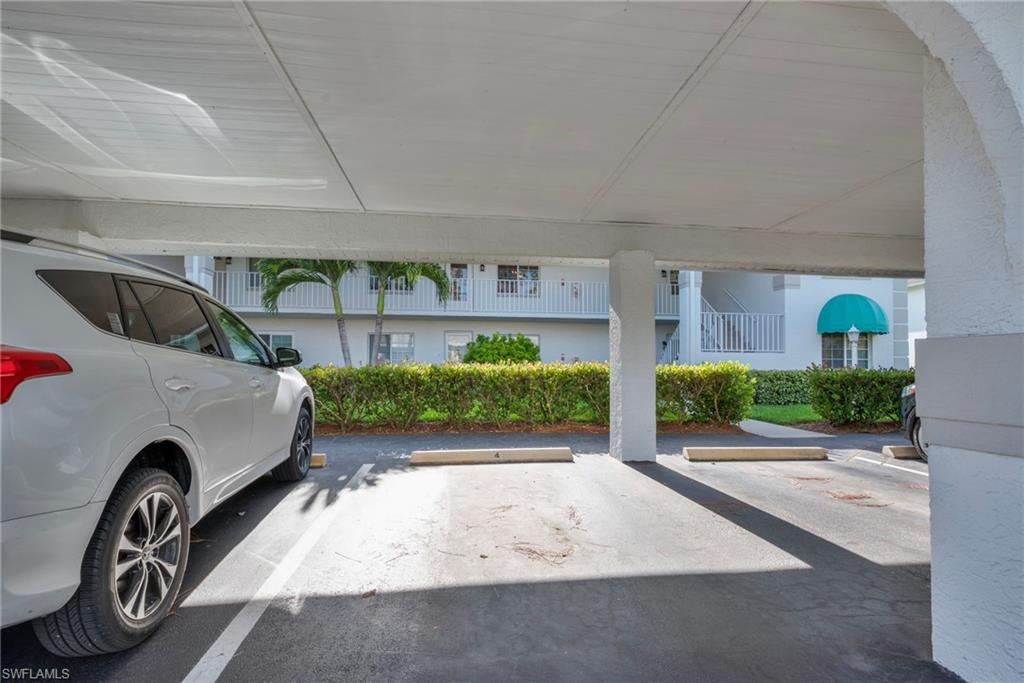 379 Gabriel Circle, Unit 2304 Naples, FL 34104 - Photo 16 of 23 a view of front door and car parked