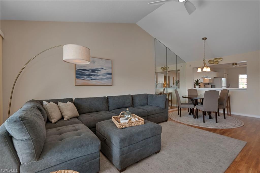 379 Gabriel Circle, Unit 2304 Naples, FL 34104 - Photo 4 of 23 a living room with furniture and a dining table