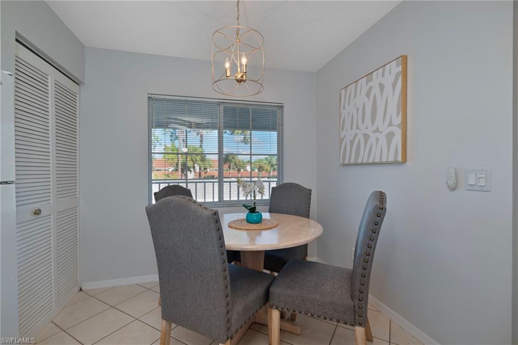 379 Gabriel Circle, Unit 2304 Naples, FL 34104 - Photo 6 of 23 a view of a dining room with furniture window and outside view