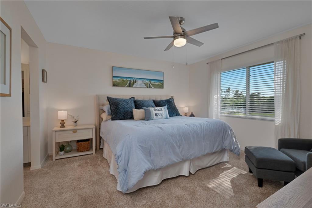 379 Gabriel Circle, Unit 2304 Naples, FL 34104 - Photo 8 of 23 a bedroom with a bed window and a couch