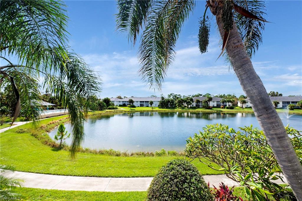 379 Gabriel Circle, Unit 2304 Naples, FL 34104 - Photo 9 of 23 a view of a lake with a beach