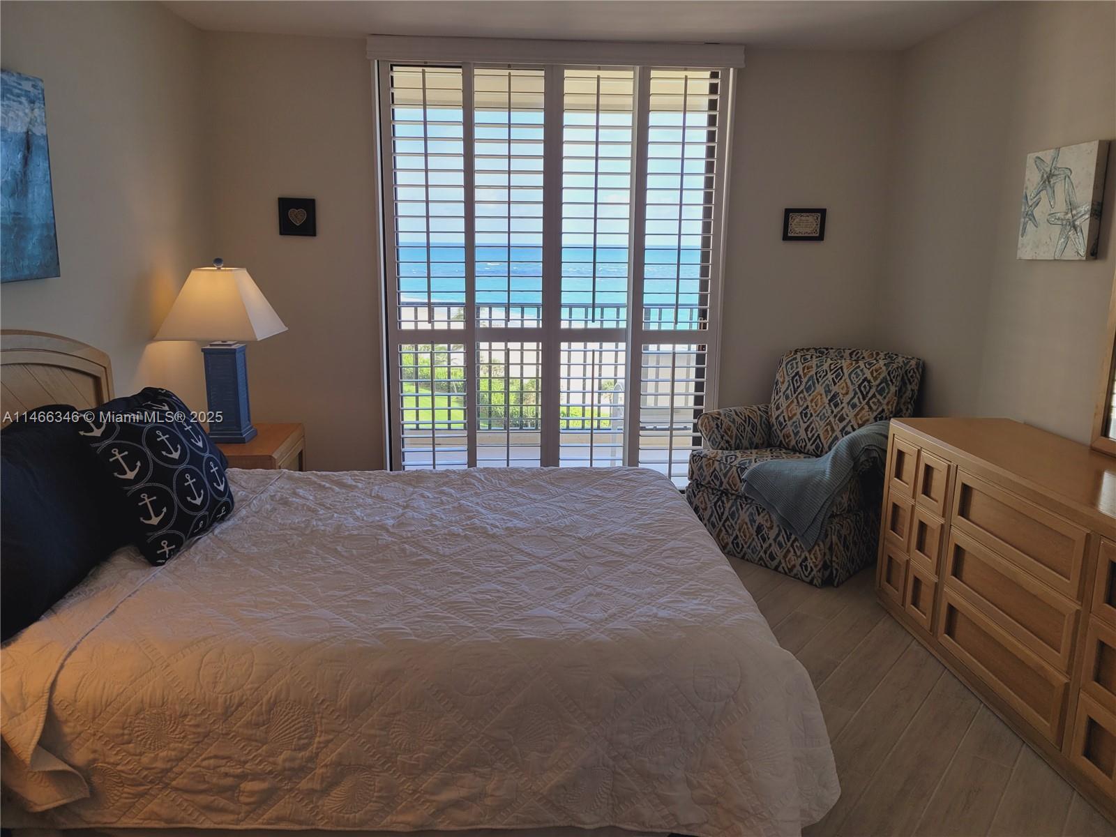 300 Ocean Trail Way, Unit 903 Jupiter, FL 33477 - Photo 11 of 19 a bedroom with bed and a large window