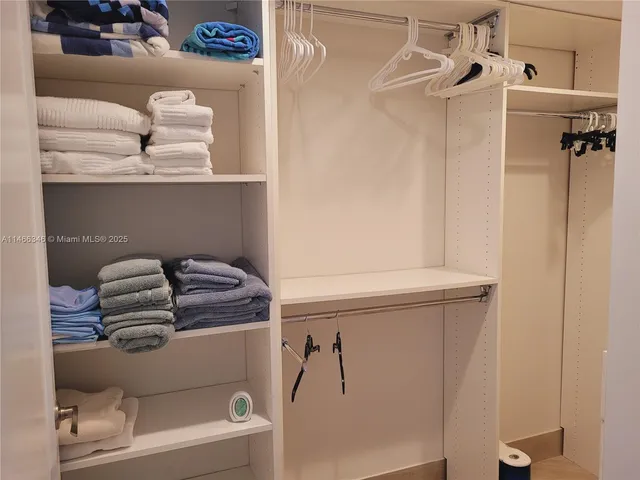 a bedroom with two beds and a window