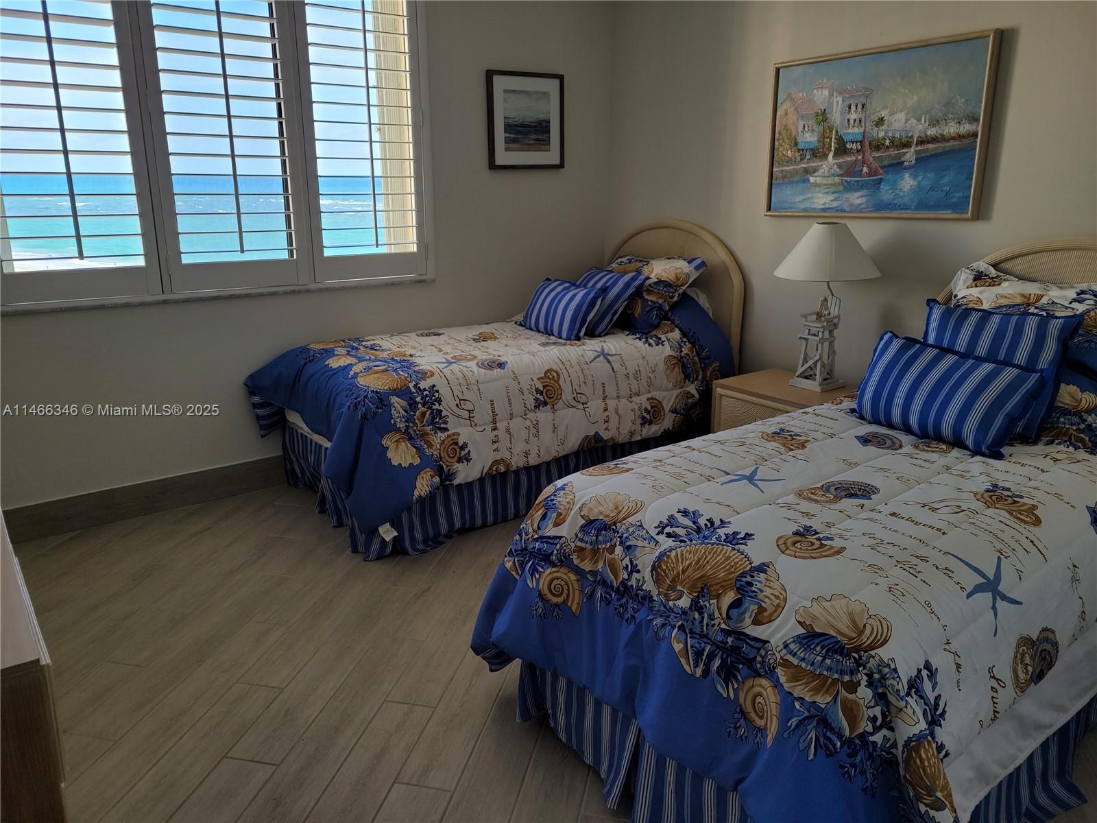 300 Ocean Trail Way, Unit 903 Jupiter, FL 33477 - Photo 15 of 19 a bedroom with two beds and a window