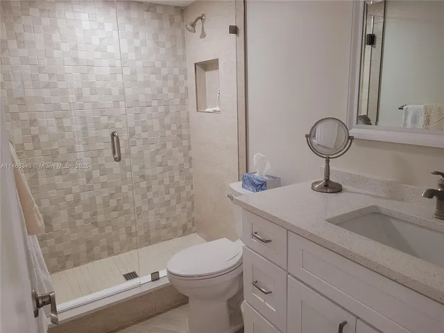 an aerial view of a house with a yard and lake view