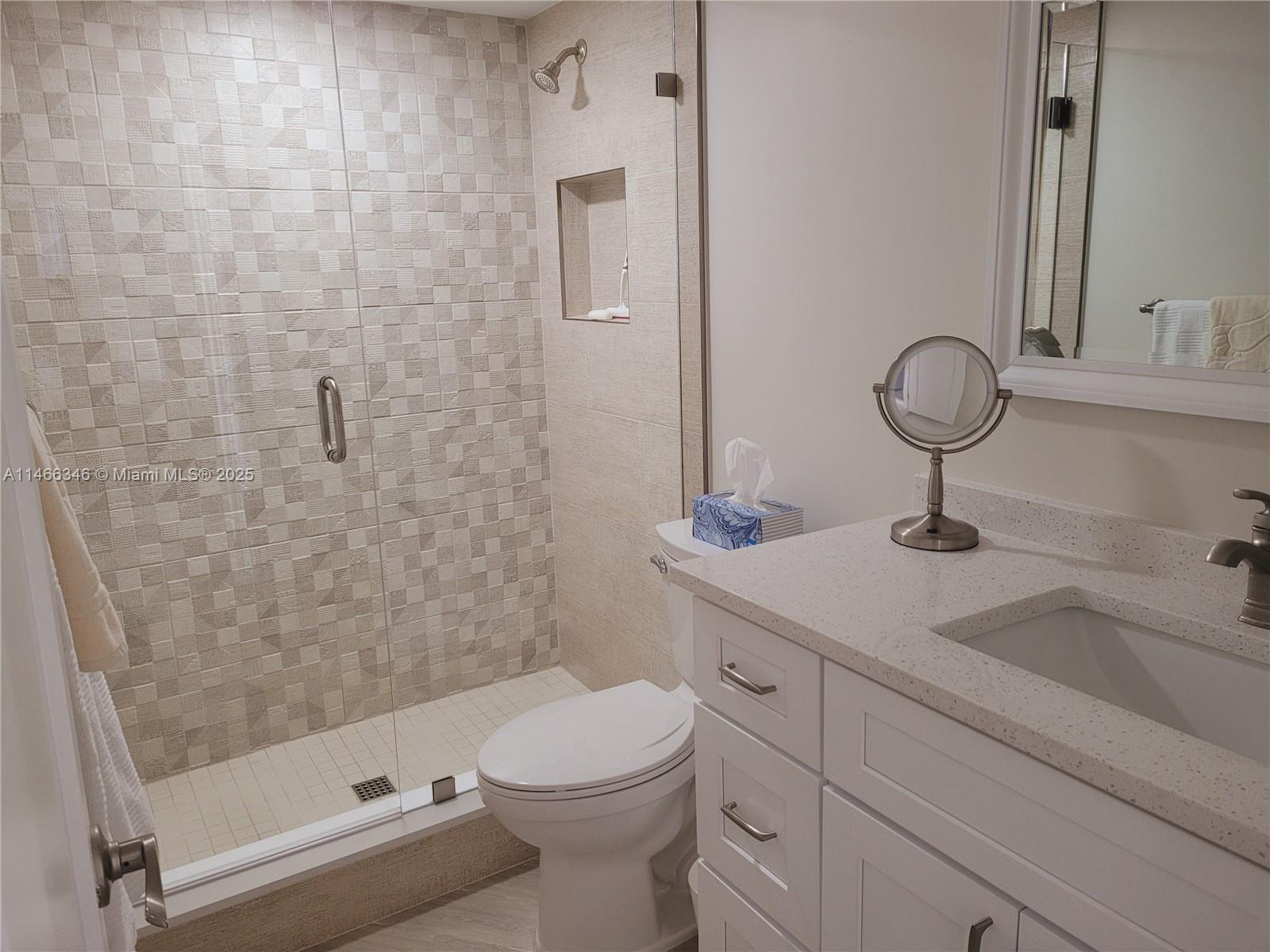 300 Ocean Trail Way, Unit 903 Jupiter, FL 33477 - Photo 16 of 19 a bathroom with a sink a toilet and shower
