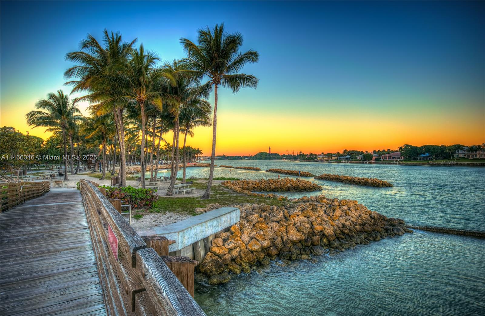 300 Ocean Trail Way, Unit 903 Jupiter, FL 33477 - Photo 17 of 19 a view of a lake with a table and chairs in patio