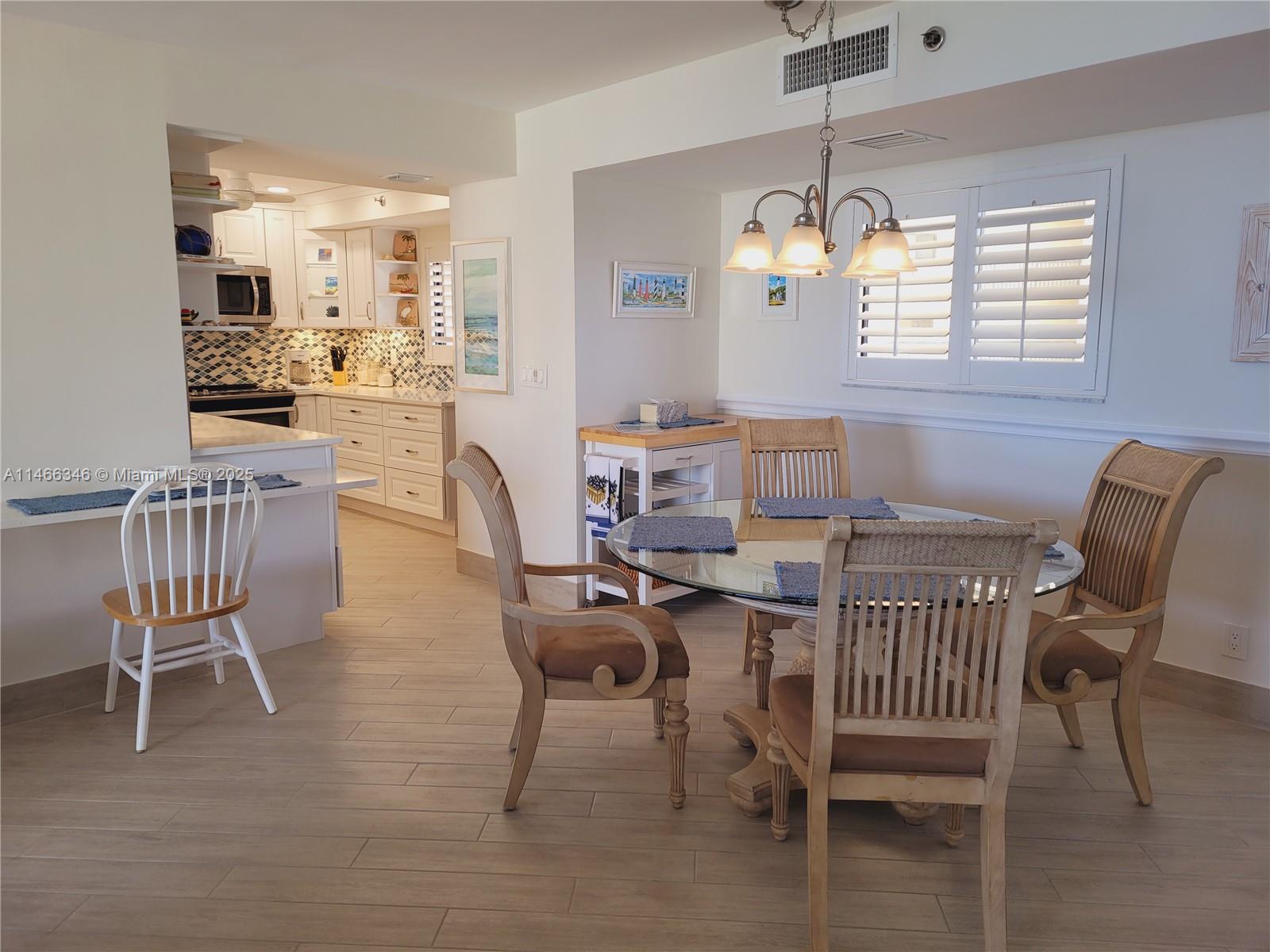 300 Ocean Trail Way, Unit 903 Jupiter, FL 33477 - Photo 9 of 19 a view of a dining room with furniture