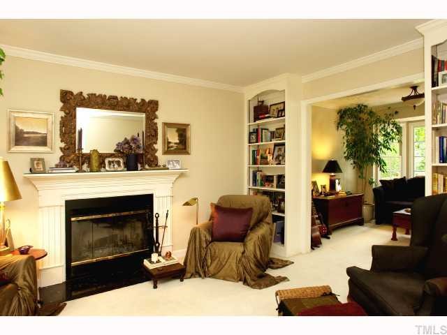 2825 Van Dyke Avenue Raleigh, NC 27607 - Photo 3 of 12 The livingroom has a wood burning fireplace, built in bookcases and is open to the formal diningroom or sitting room with bay window.